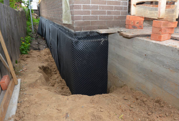 SJ Waterproofing Pros technician performing targeted Wet Basement Repair assessment in Berlin Heights, OH